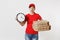 Woman in red cap, t-shirt giving food order pizza boxes isolated on white background. Female pizzaman courier dealer