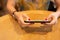 Woman with red color nail using cell phone.