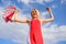 Woman red dress carries bunch shopping bags blue sky background. Girl satisfied with purchases. Feel free buy everything