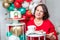 Woman in red dress with Christmas cake. Inscription Good Christmas. Happy holiday concept
