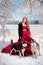 Woman on red dress with dogs. Fairy tale girl Huskies or Malamute. Christmas.