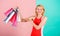 Woman red dress hold bunch shopping bags blue pink background. Buy everything you want. Girl satisfied with shopping