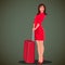 Woman in red dress holding travel bag. Travelling worldwide as a tourist