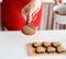 Woman in red dress making valentine cookies at the kitchen