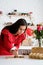 Woman in red dress making valentine cookies at the kitchen