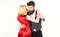 Woman in red dress and man in vest. Bearded hipster and attractive lady dressed up for dancing contest. Couple in love