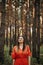 Woman in red dress relaxing outdoor in pine forest. Mindfulness, wellbeing, Mental health, wellness,