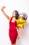 Woman in red dress with shaped balloon take selfie from phone
