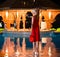 Woman in red dress standing in pool water