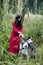 Woman in red dress with tree wolfs in forest