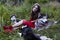 Woman in red dress with tree wolfs in forest