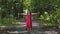 Woman in red enjoys nature, feels unity with divine forest spirits, blessing