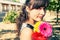 Woman with red flower walking with flowers in her hands