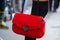 Woman with red fur bag with heart before Ermanno Scervino fashion show, Milan Fashion Week street style on