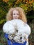 A woman with red hair proudly shows the big mushroom she has found, a giant bovist