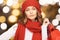 Woman in red hat and scarf holding shopping bags