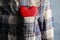 Woman with red heart in pocket, closeup.