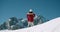 Woman in red jacket walk on mountain top at winter travel adventure raise hands