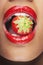 Woman With Red Lips Eating Strawberry