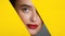 Woman With Red Lips Peering Into Hole In Yellow Paper