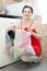 Woman in red loading the washing machine
