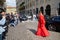 Woman with red, long dress surrounded by photographers before Blumarine fashion show, Milan Fashion Week