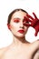 Woman with red makeup and painted hand