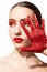 Woman with red makeup and painted hand