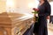 Woman with red roses and coffin at funeral