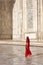 Woman in red saree at Taj Mahal.