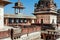 Woman in red sari walling on the 17th century Citadel of Jahangir with towers and arches, India. Fort in Orchha city