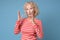 Woman in red shirt discussing telling her opinion, showing something with hands.