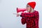 Woman in red shirt and hat with loud shout with megaphone