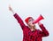 Woman in red shirt and hat with loud shout with megaphone