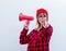 Woman in red shirt and hat with loud shout with megaphone