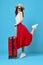 woman in red skirt luggage vacation travel flight destination
