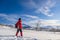 Woman in red sports jacket savors snow and breathtaking Norwegian landscape