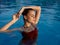 woman in red swimsuit in the pool and glamor luxury enjoyment