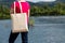 Woman in red tee holding tote bag mockup