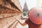 Woman with red umbrella overlooking pagoda and temple of ancient Bagan in Myanmar