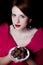 Woman in red Victorian epoch clothes with chocolate candy