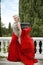 Woman in red waving dress. Fashion blond model in blowing gown o