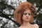 Woman with RedOrange Teased Hair with Dead Flowers