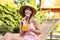 Woman with refreshing drink resting in deck chair outdoors
