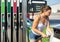 Woman refuelling her car at petrol filling station