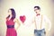 woman rejecting the red heart of her boyfriend in a Funny Valentine`s Day