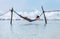 Woman relax lying in hammock swing over the ocean surf line