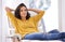 Woman, relax and portrait on work break in a chair in a home with smile and calm in a lounge with rest. Happy, chill and