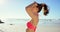 Woman, relax and summer holiday, beach travel and relax in Hawaii while tying hair in bikini, sunglasses and blue sky at