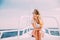 Woman relax in sunglasses on white yacht in on ocean waves